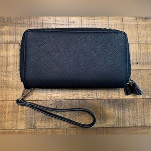 Black clutch / wristlet. Gold colored metal detailing. Never used (NWOT)